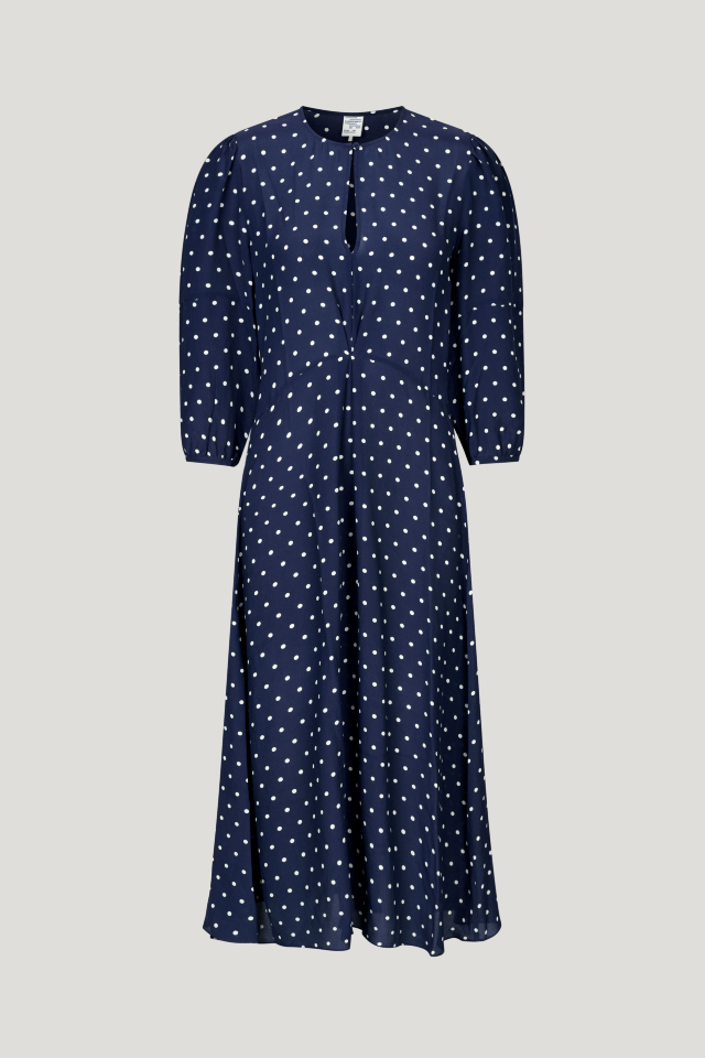 Adya Dress Blue Margot Dot This midi-length dress features cropped sleeves, a button closure with keyhole opening at the neck, and a pleat in the middle for a flattering drape - front image