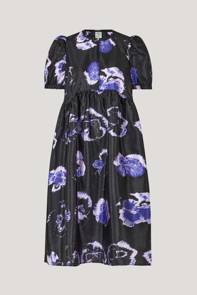 Artemis Dress Purple Pansy This midi-length dress features a button closure with keyhole opening at the front, pockets at the sides, slight puffing at the skirt, and a dipped waistline - front image