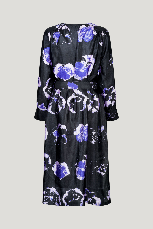 Aradina Dress Purple Pansy This midi-length dress has a removable tie at the waist, side pockets, V-neck, and cuffed sleeves - back image
