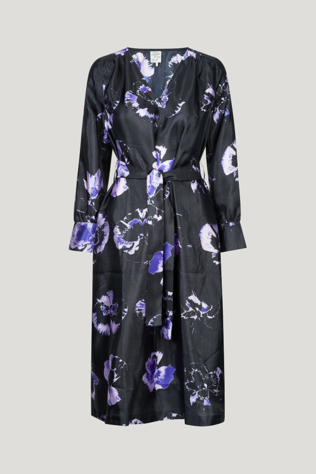 Aradina Dress Purple Pansy This midi-length dress has a removable tie at the waist, side pockets, V-neck, and cuffed sleeves - front image