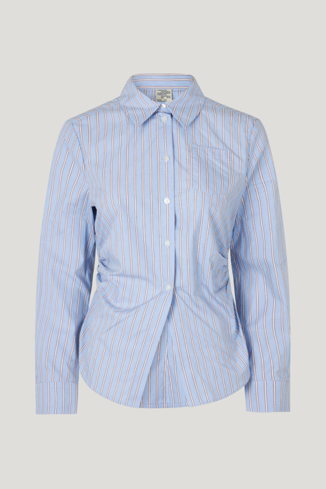 Maria Shirt Blue Margot Stripe This button up shirt feautres a curved hem and gatherings at the sides for a flattering drape - front image