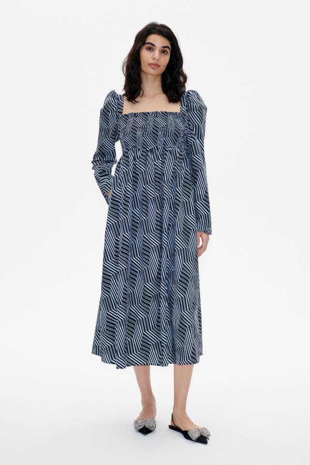 Amayra Dress Blue Zebra This midi-length dress features an empire waist, stretchy smocking across the chest and back, and a square neckline - model image