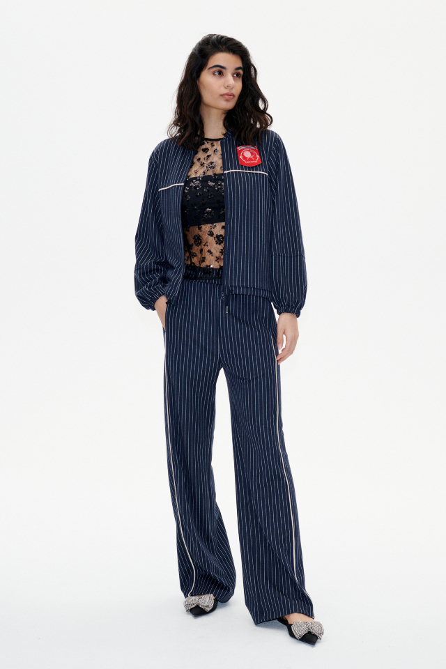 Janka Trousers Tracksuit Pinstripe These soft trousers feature an elasticated waistband, pockets at the sides and back, and raised track stripes down the sides - model image