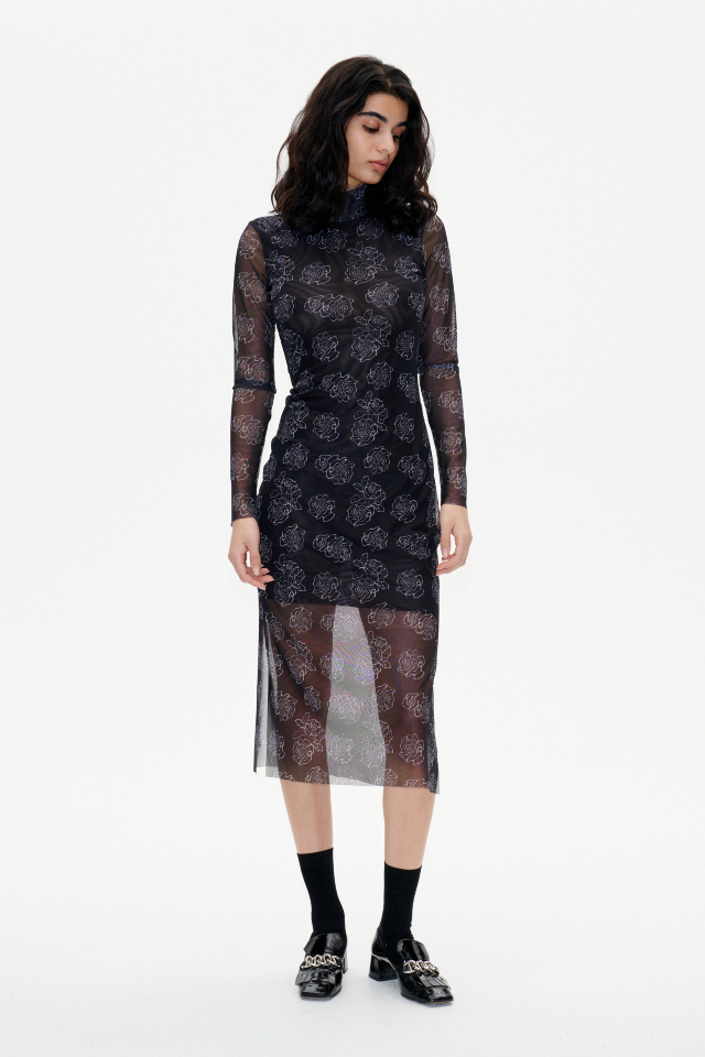 Jolain Dress Black Embroidery Flower This stretchy, mid-calf length turtleneck dress features slits at the sides and an interior slip to the knee - model image