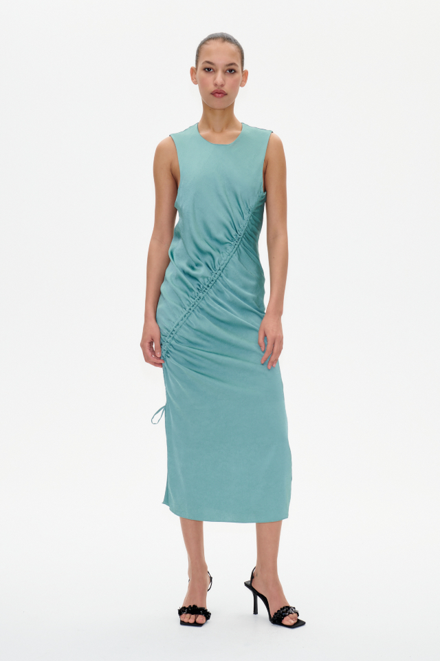 Allanna Dress Trellis This midi-length, sleeveless dress features a button closure with keyhole opening in the back and ruching with an asymmetrical drawstring across the front - model image