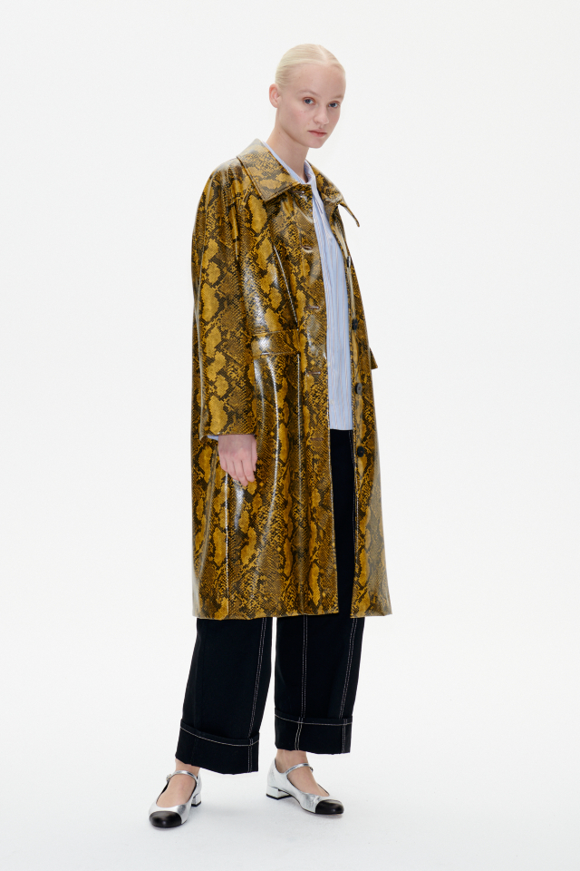 Devon Coat Yellow Snake This coat features button closures in the front, patch pockets, and a patent finish - model image