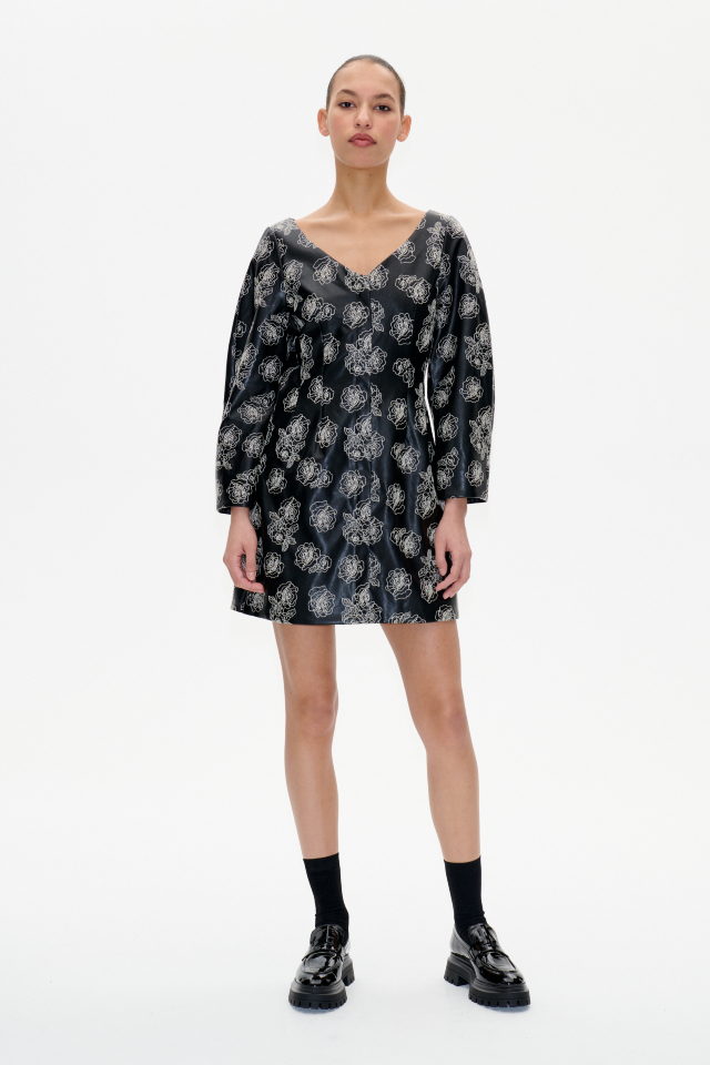 Arohi Dress Black Stitch Flower This structured minidress features a hidden zip closure at the front, cropped sleeves, and a V-neck silhouete - model image