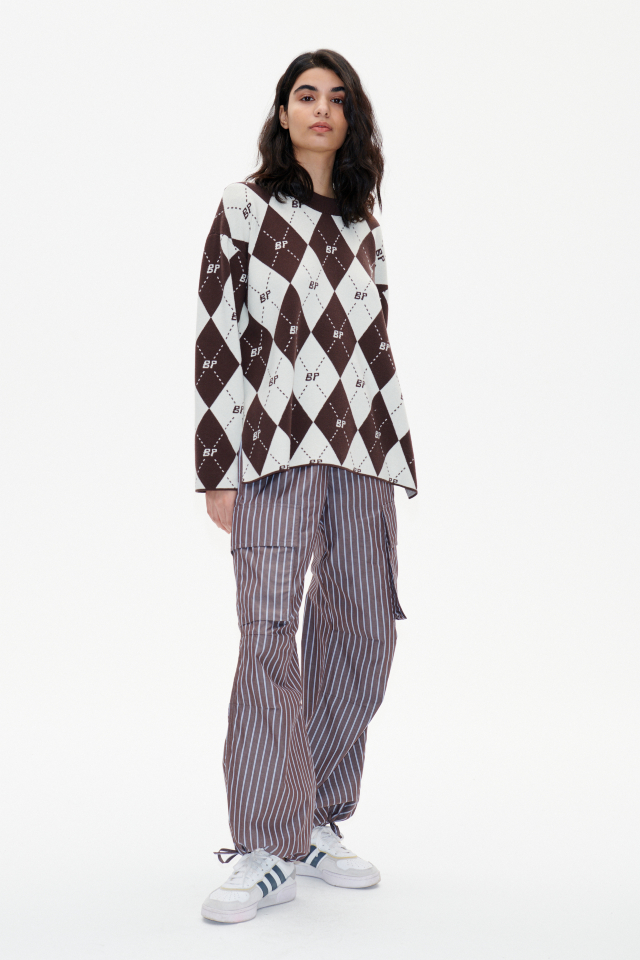 Nasreen Trousers Brown Margot Stripe These low-rise trousers feature wide legs, an elasticated waistband with a drawstring tie, and drawstring ties at the ankles - model image